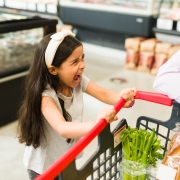 little girl throwing a tantrum in a grocery store