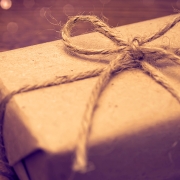 Gift wrapped in paper on the wooden background