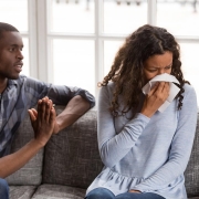 Frustrated African American man apologizing to woman after quarrel