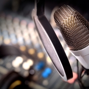 Recording equipment in studio. Studio microphone with headphones and mixer background