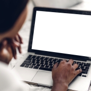 Young african american black woman relaxing and using laptop computer with white mockup blank screens