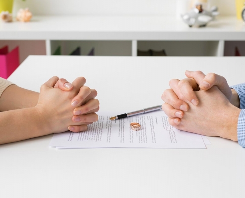 Couple going through divorce signing papers