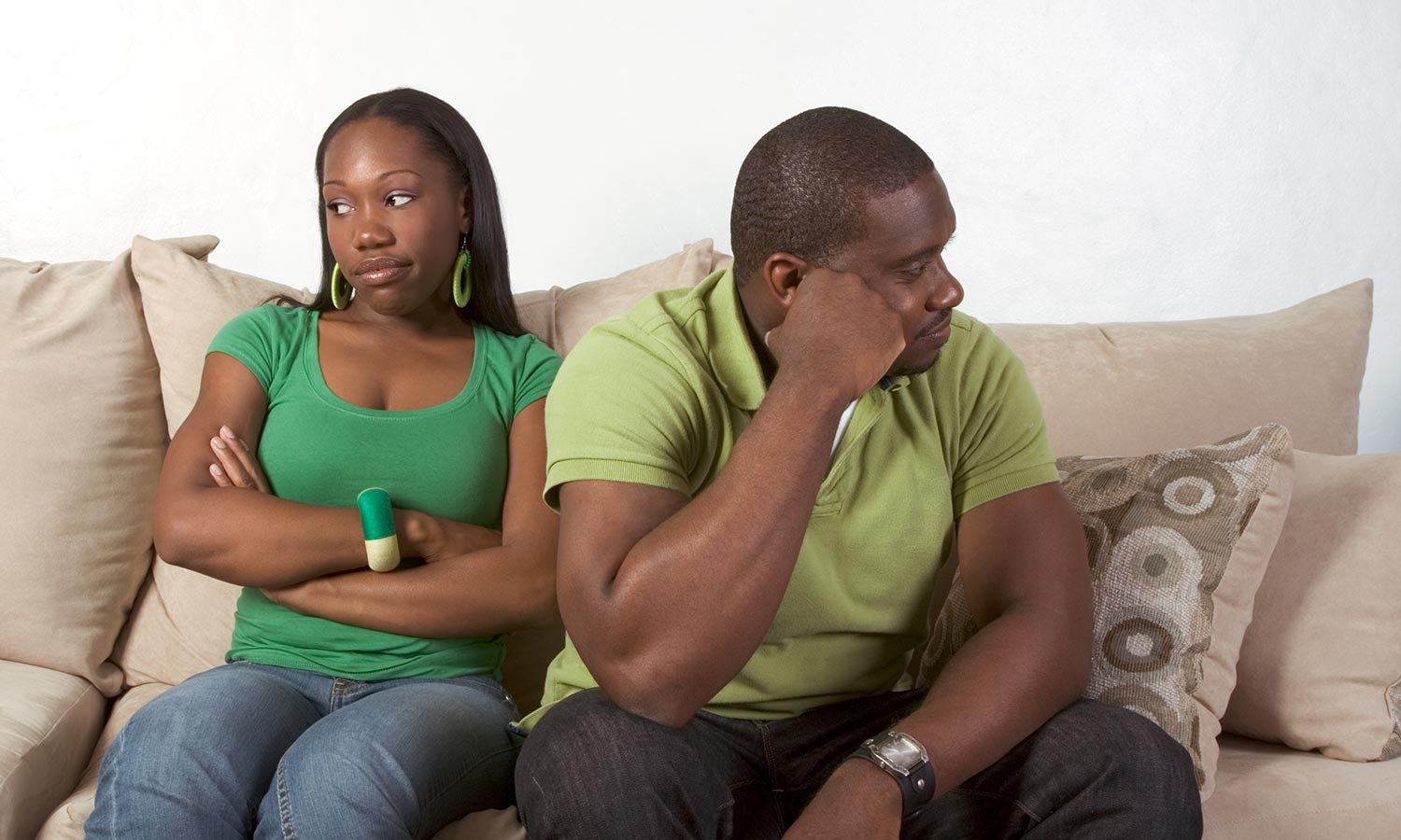 Young black ethnic African-American couple at odds and bad mood not talking with each other and looking away after heated argument