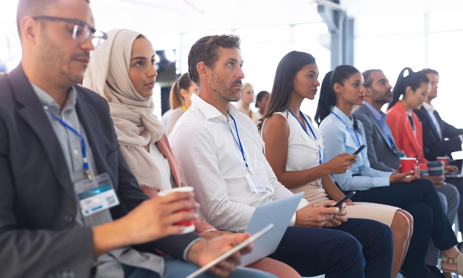 Workshops & Training (Side view of diverse audience listening to speaker)